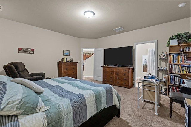 bedroom featuring visible vents and light carpet