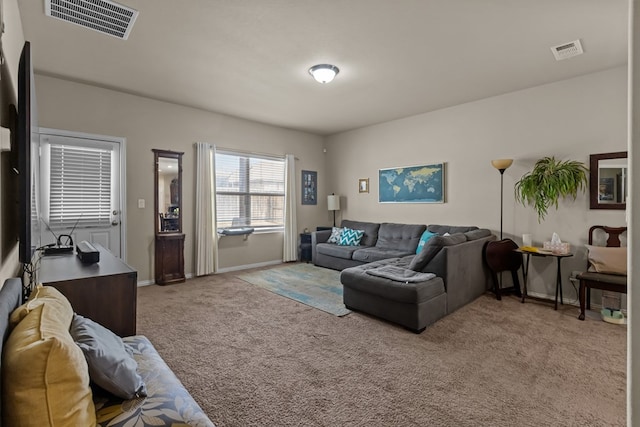 living area featuring light colored carpet, visible vents, and baseboards