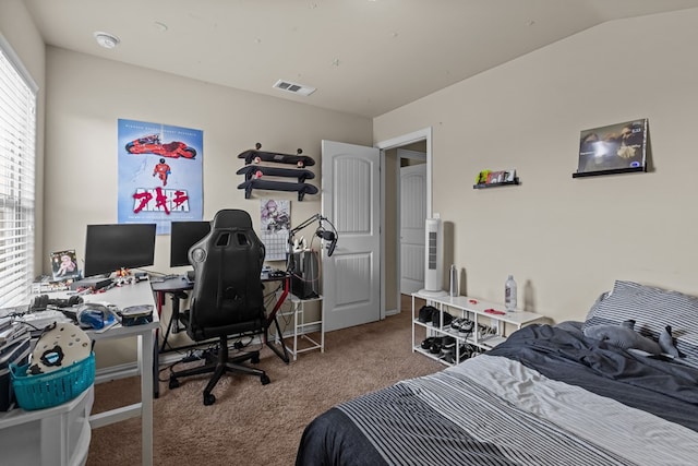 bedroom with vaulted ceiling, carpet, and visible vents