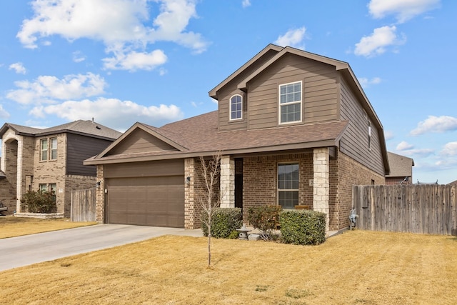 traditional-style home featuring a garage, brick siding, driveway, and fence