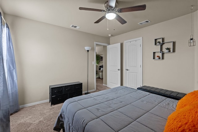 carpeted bedroom with visible vents, baseboards, and a ceiling fan