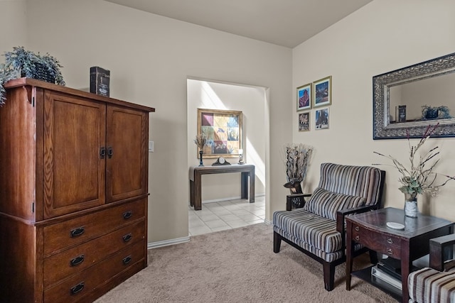 living area featuring light tile patterned floors and light colored carpet