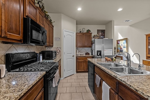 kitchen featuring visible vents, black appliances, a sink, recessed lighting, and light tile patterned floors