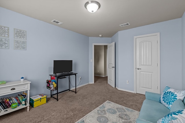 carpeted living area with baseboards and visible vents