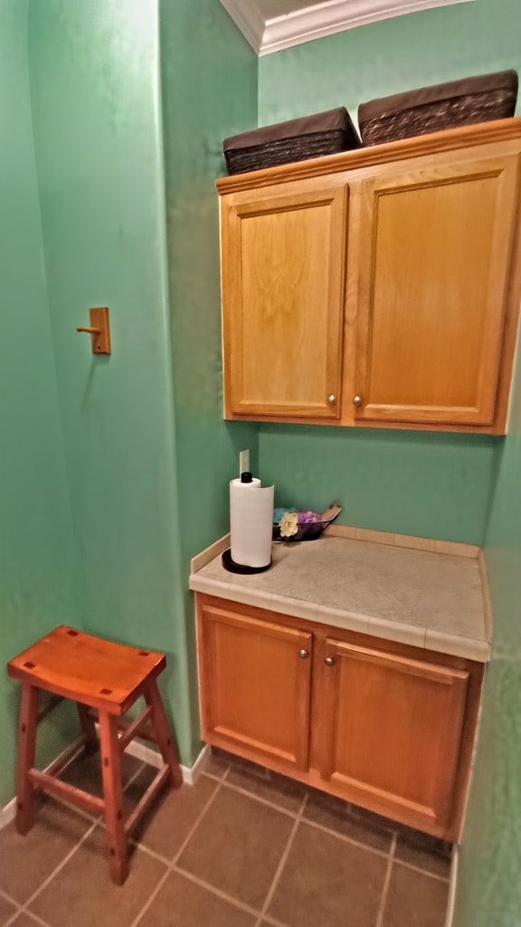 bathroom featuring tile patterned floors and ornamental molding