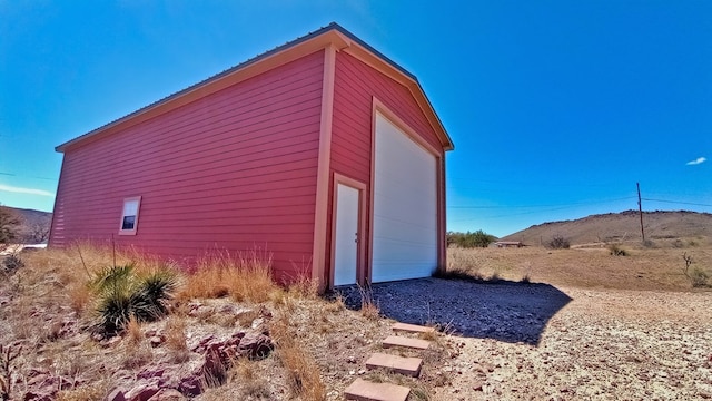 view of property exterior with a garage and an outdoor structure