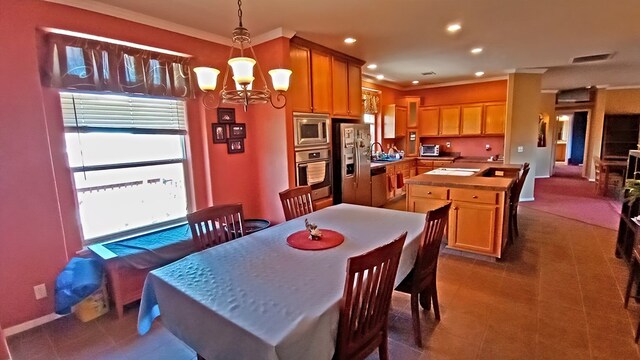 dining space with a healthy amount of sunlight, crown molding, and a chandelier