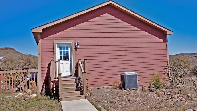 exterior space featuring a mountain view and central air condition unit