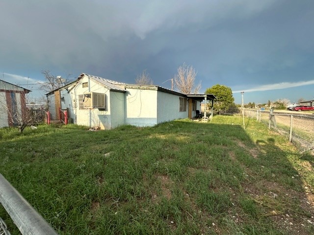 view of side of home with a lawn