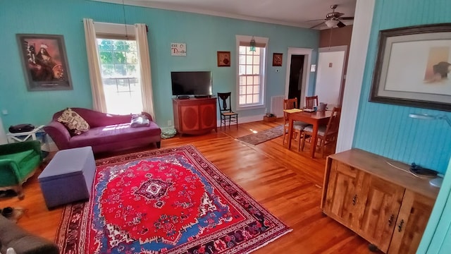 living room with hardwood / wood-style floors and ceiling fan