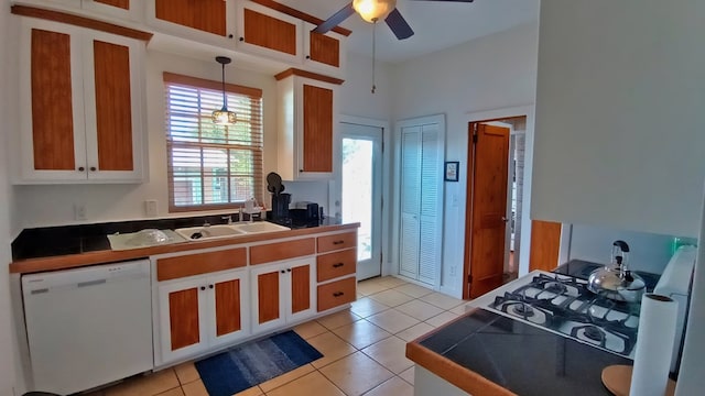 kitchen with ceiling fan, sink, hanging light fixtures, white dishwasher, and light tile patterned floors