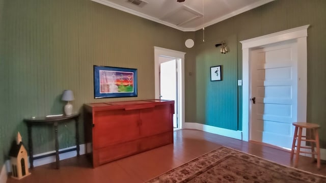 interior space featuring hardwood / wood-style floors and crown molding