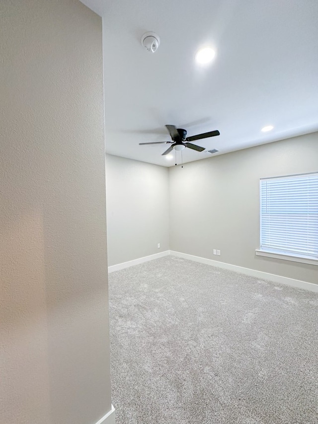 empty room featuring carpet flooring and ceiling fan