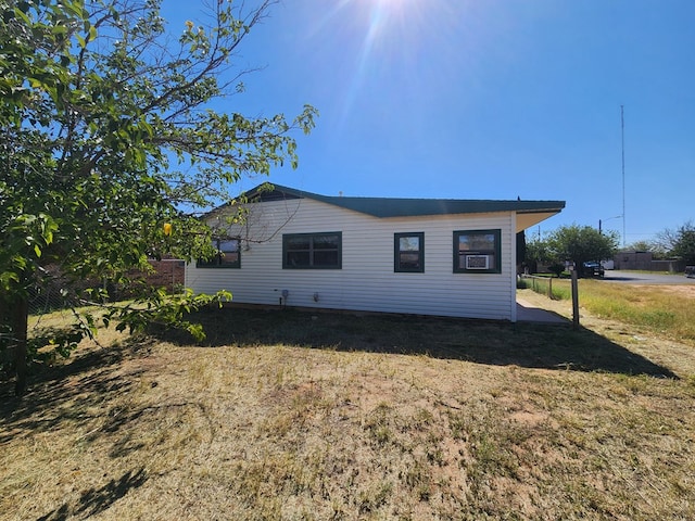 view of side of home featuring a yard