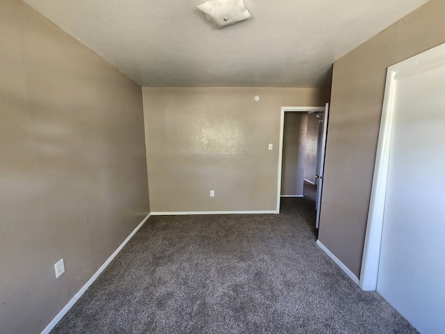 unfurnished bedroom featuring dark colored carpet