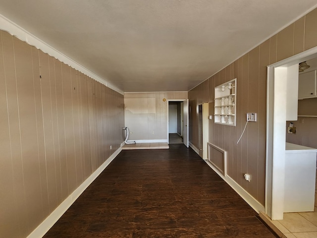 hall featuring wood walls and dark wood-type flooring