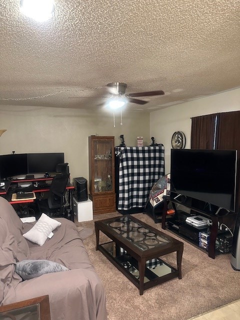 carpeted living area featuring a textured ceiling and ceiling fan