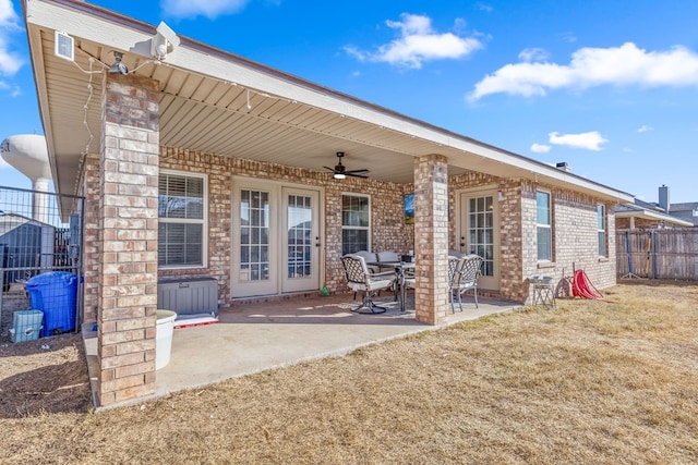 rear view of property with a lawn, ceiling fan, and a patio