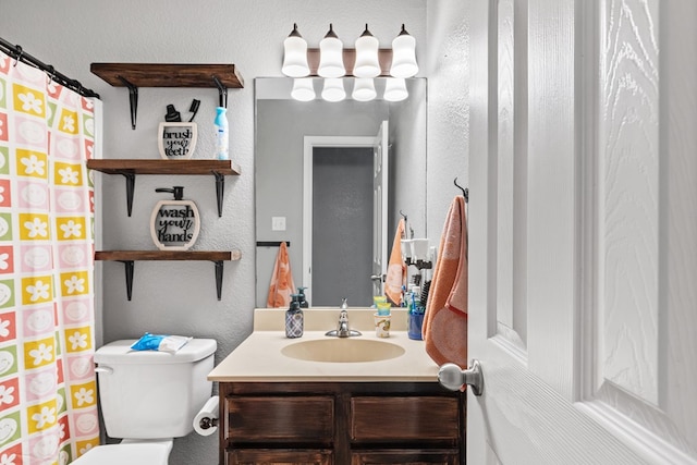 bathroom featuring vanity and toilet