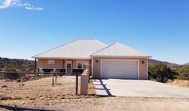 view of front of property with a mountain view and a garage