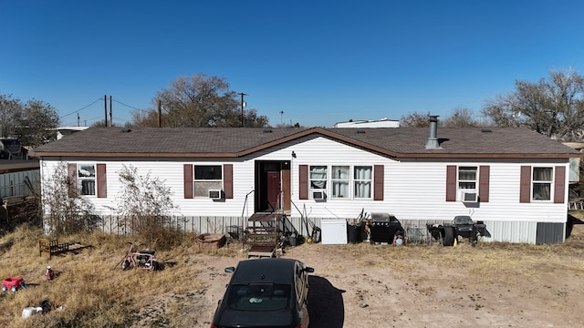 rear view of property with cooling unit