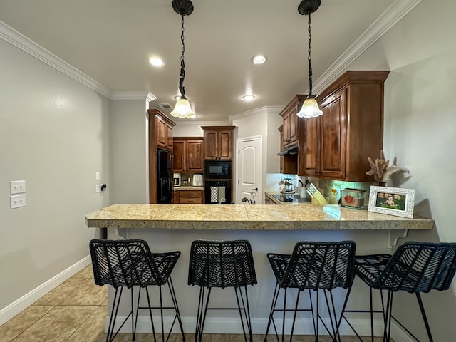 kitchen with kitchen peninsula, a breakfast bar, and black appliances