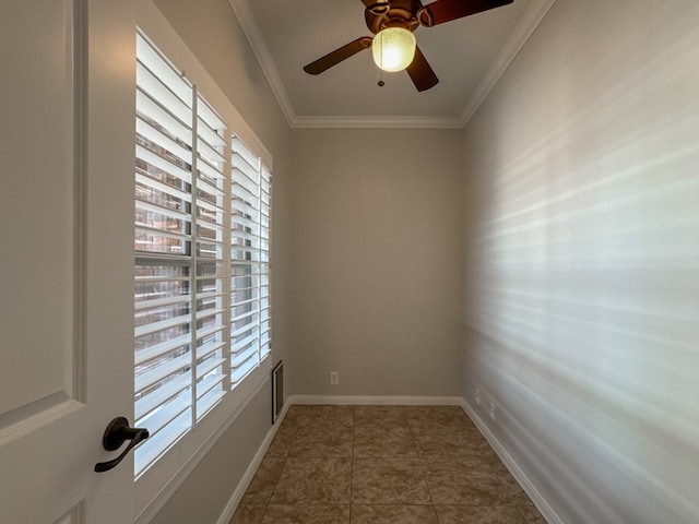 empty room with tile patterned floors, ceiling fan, and crown molding