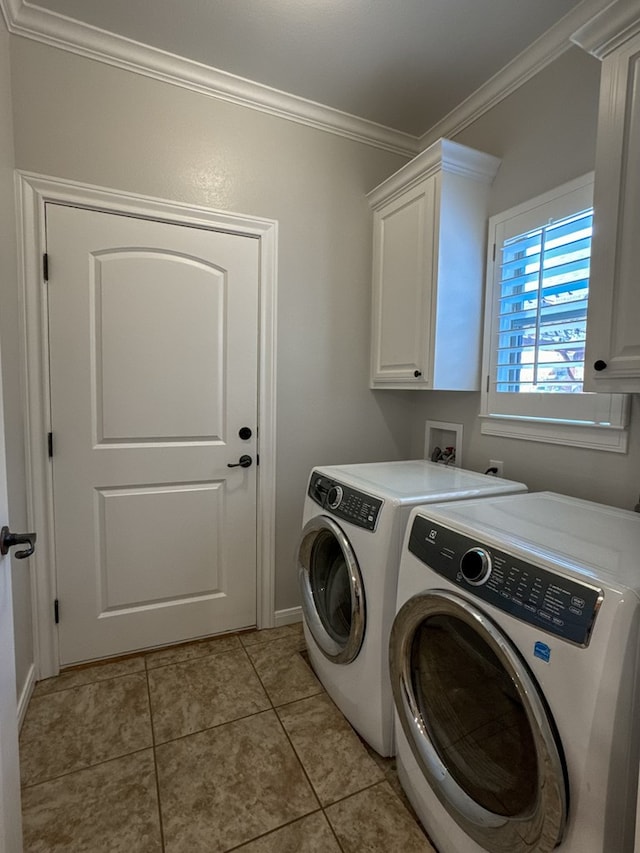 washroom with cabinets, light tile patterned floors, washer and dryer, and ornamental molding