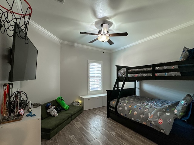 bedroom featuring ceiling fan, dark hardwood / wood-style flooring, and crown molding