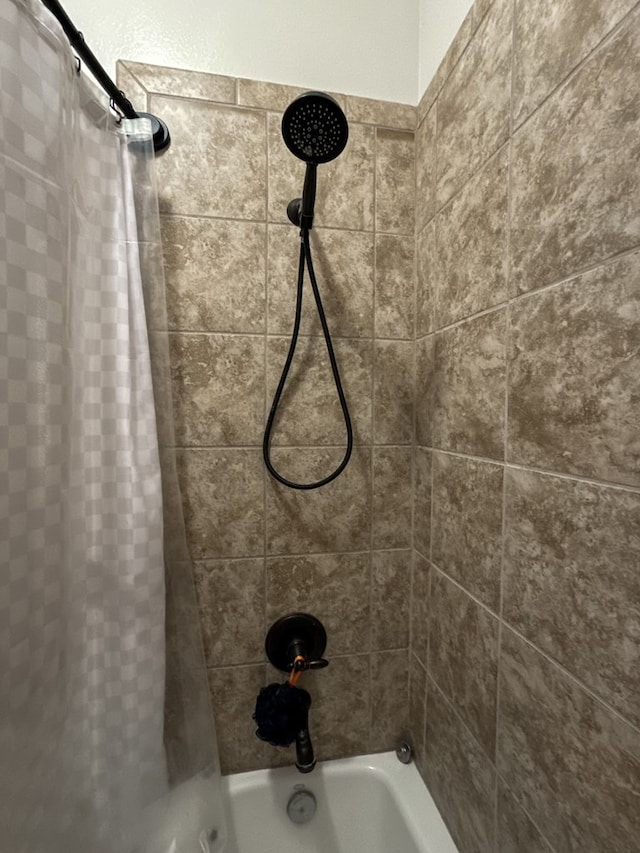 interior details featuring shower / bath combo