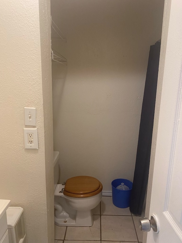 bathroom featuring tile patterned floors, vanity, and toilet