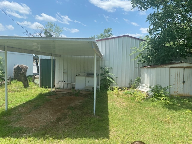 view of outbuilding featuring a yard and a carport