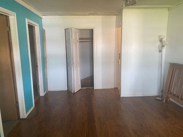 unfurnished bedroom with dark wood-type flooring