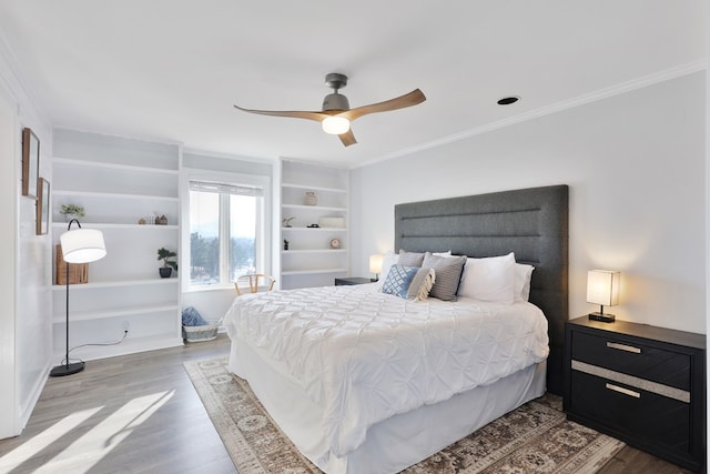 bedroom featuring ceiling fan, wood finished floors, and ornamental molding