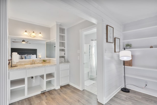 full bath featuring vanity, crown molding, and wood finished floors