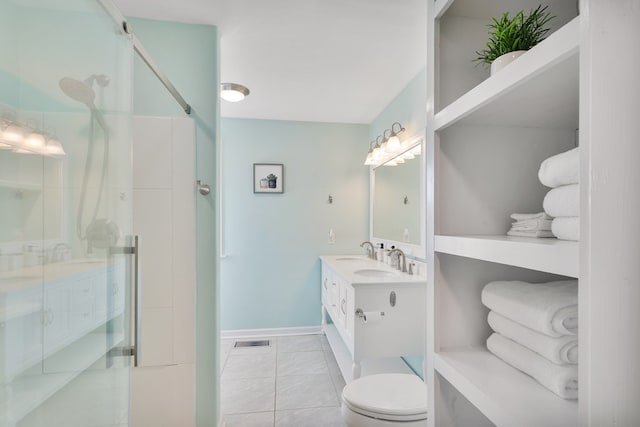 full bathroom featuring a shower stall, baseboards, toilet, tile patterned floors, and vanity