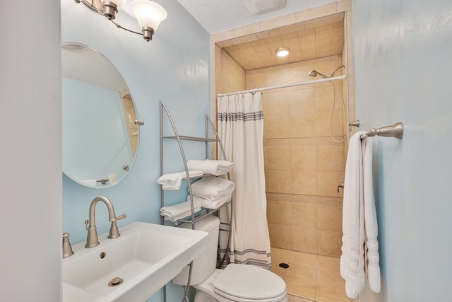 bathroom with a sink, toilet, and a tile shower