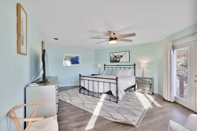 bedroom featuring access to exterior, ceiling fan, baseboards, and wood finished floors