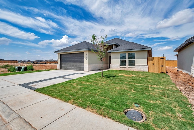 view of front of house with a garage and a front lawn