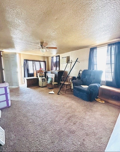 carpeted living room with an AC wall unit, ceiling fan, and a textured ceiling