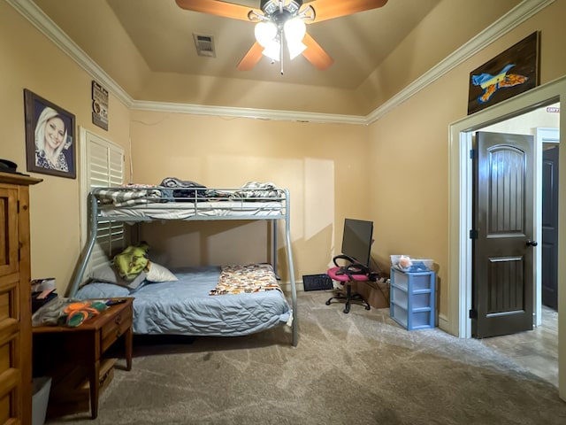 bedroom with crown molding, ceiling fan, a raised ceiling, and carpet