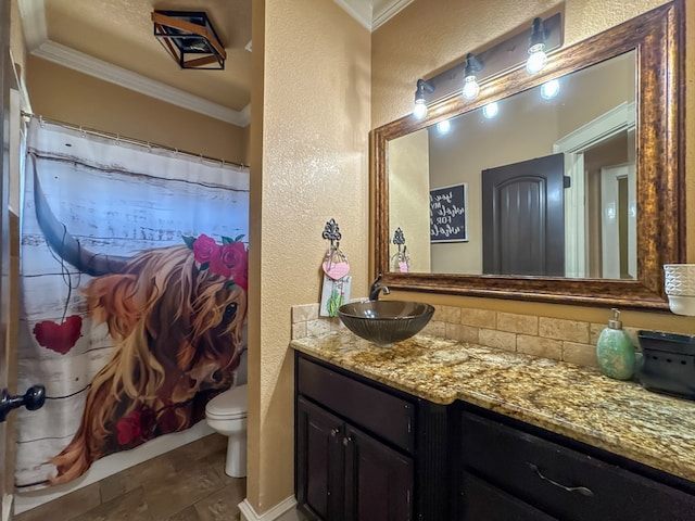 bathroom featuring ornamental molding, toilet, and vanity