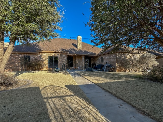 rear view of house with a yard