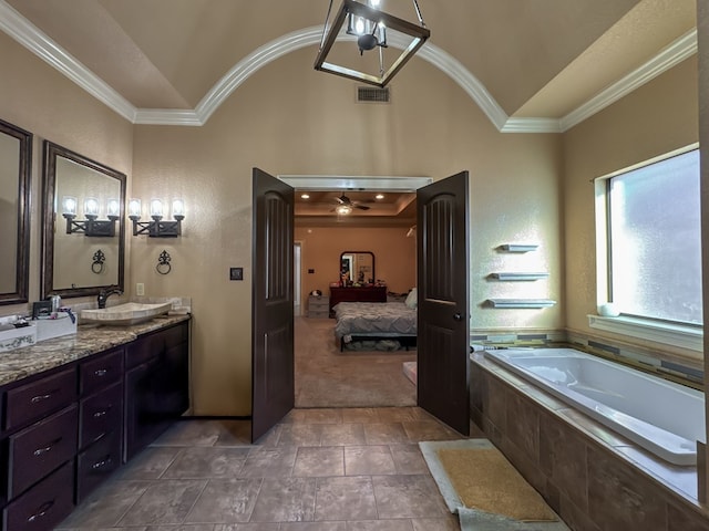 bathroom featuring crown molding, vanity, tiled bath, and high vaulted ceiling