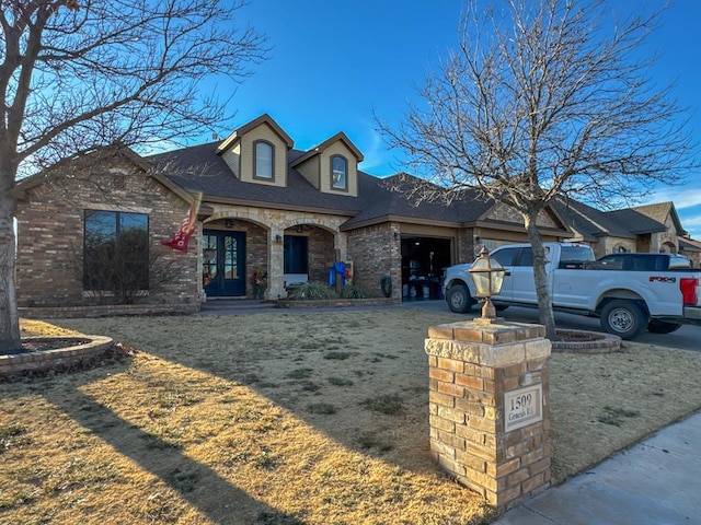 view of front facade with a garage and a front lawn