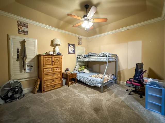 bedroom with ornamental molding, carpet, and a tray ceiling