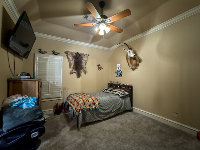 carpeted bedroom featuring a tray ceiling, crown molding, and ceiling fan