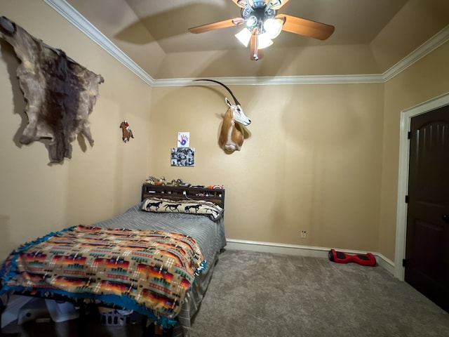 bedroom featuring a raised ceiling, crown molding, carpet floors, and ceiling fan