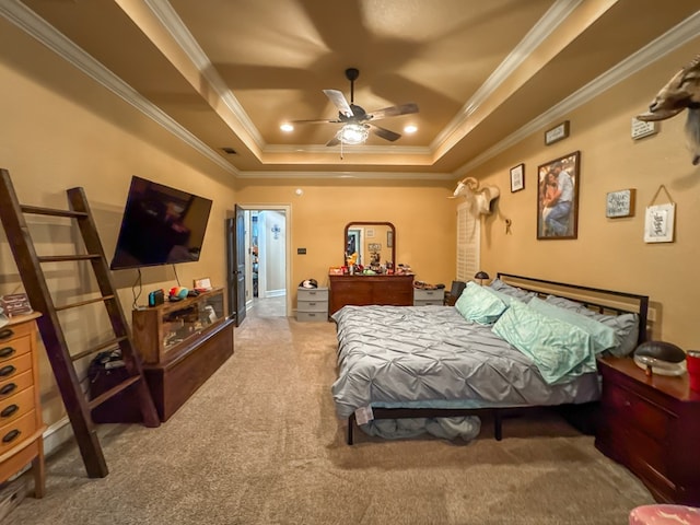 bedroom with ornamental molding, carpet flooring, and a raised ceiling