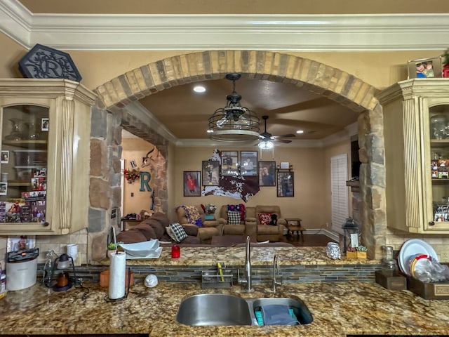 kitchen featuring crown molding, ceiling fan, sink, and cream cabinetry